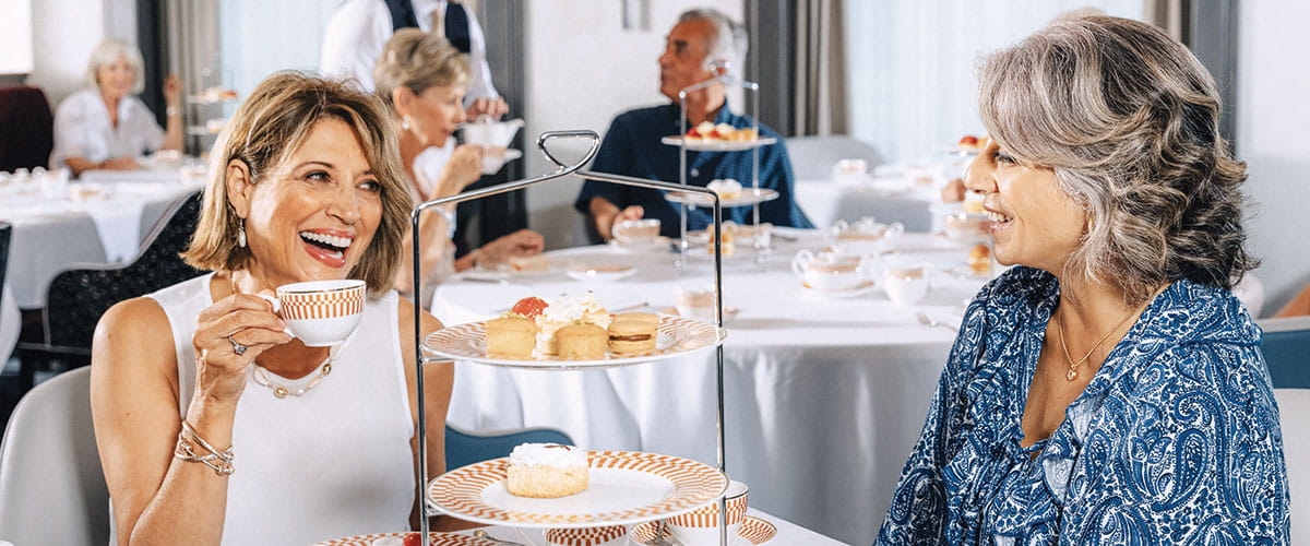 Two friends enjoying afternoon tea on Spirit of Adventure